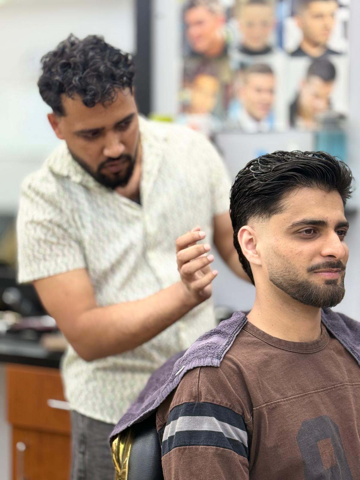 Ashok cutting a client's hair at AONE Style Studio